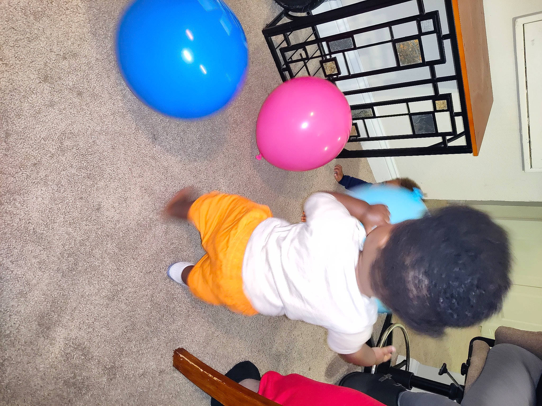 Jalen is registered to the contest to win money with this photo: balloon, blue, child, circle, comfort, design, electric_blue, flooring, fun, learning, leisure, organ, party_supply, person, play, room, sitting, snapshot, sock, t_shirt