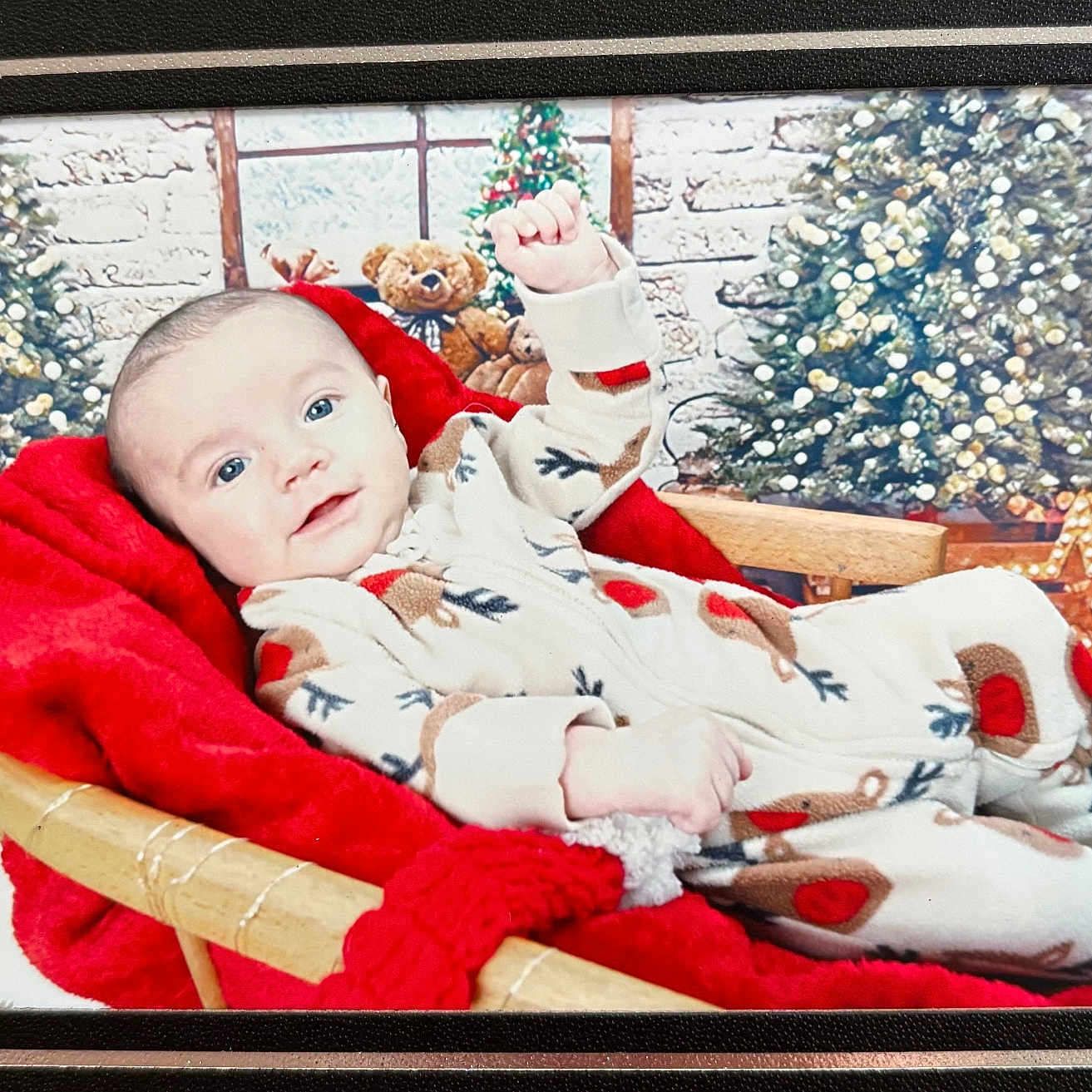 Oskar is registered to the contest to win money with this photo: baby, celebration, child, christmas_tree, cozy, cute, decoration, festive, holiday_decor, indoors, infant, portrait, red_blanket, reindeer_onesie, seasonal, smiling, teddy_bear, warmth, wicker_basket, wood_floor