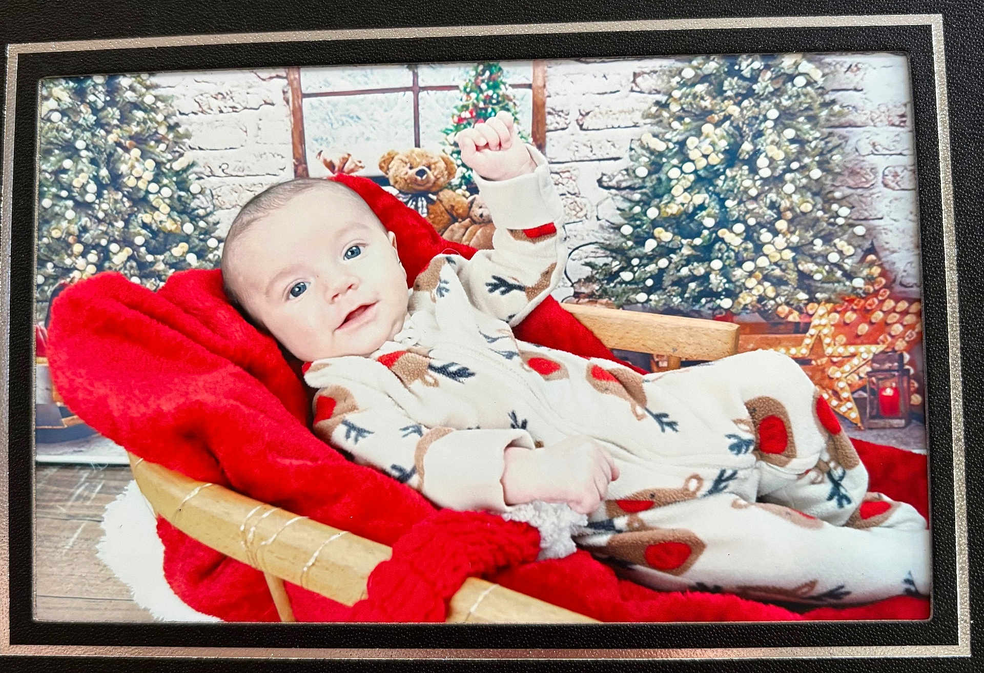 Oskar is registered to the contest to win money with this photo: baby, infant, reindeer_onesie, red_blanket, wicker_basket, christmas_tree, holiday_decor, teddy_bear, smiling, indoors, festive, cozy, cute, child, portrait, seasonal, decoration, wood_floor, warmth, celebration