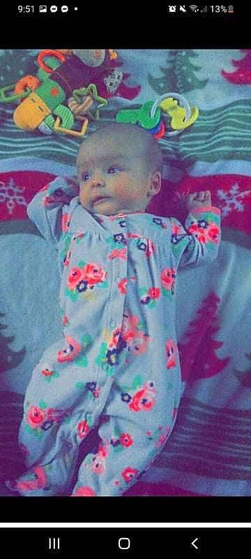 Carmila is registered to the contest to win money with this photo: baby, baby_toddler_clothing, cheek, child, dress, electric_blue, face, fun, happy, linens, magenta, pattern, peach, person, petal, pink, plant, skin, sleeve, t_shirt