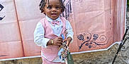 Noah joined the competition — help win amazing prizes! toddler, child, boy, pink_suit, bow_tie, braids, keys, white_shoes, concrete_floor, castle_backdrop, outdoor, standing, portrait, fashion, accessories, happy, cute, small_person, event, background