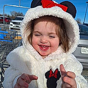 Hayzleigh joined the competition — help win amazing prizes! child, toddler, baby, hood, fluffy_hood, winter_coat, white_coat, minnie_mouse, red_bow, smiling, laughing, baby_teeth, outdoors, parking_lot, shopping_cart, cars, sunny, happy, portrait, close_up