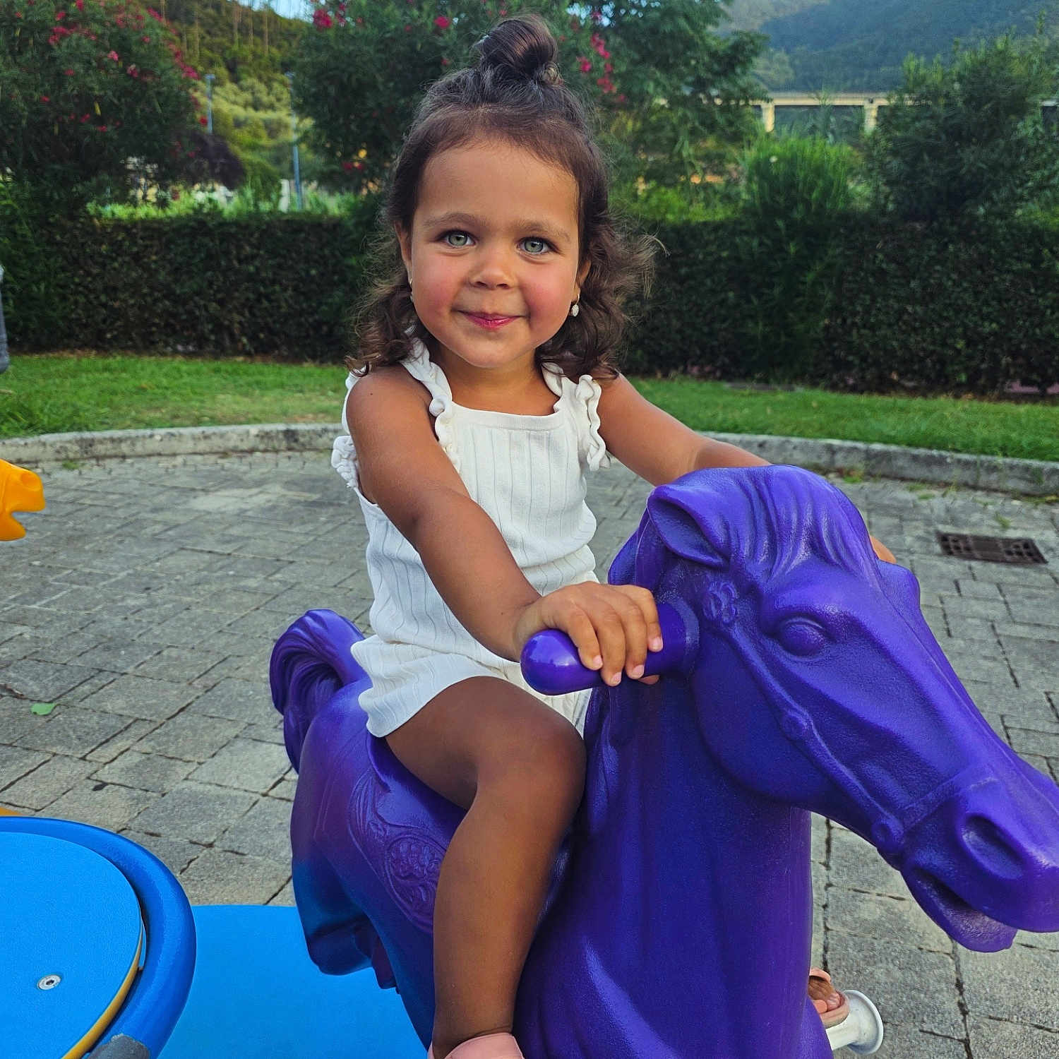 Irina Caruntu a rejoint le concours — aidez-le/la à gagner de superbes lots ! child, curly_hair, cute, daylight, face, fun, girl, greenery, happy, joy, outdoor, park, person, play, playground, purple_horse, smile, summer, toy, white_dress