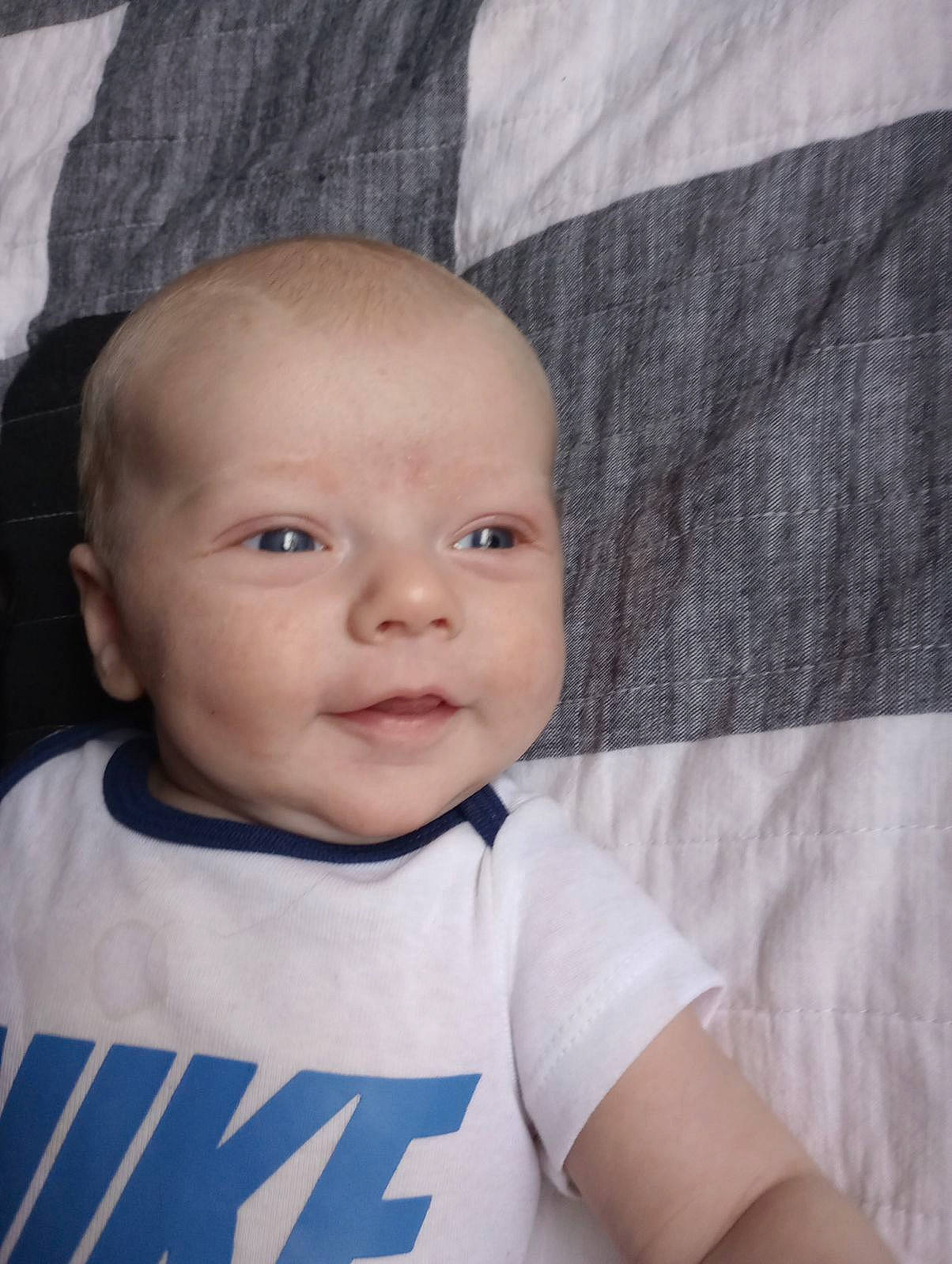 Atlas is registered to the contest to win money with this photo: baby, baby_toddler_clothing, cheek, comfort, electric_blue, eyebrow, flash_photography, happy, head, iris, linens, lip, nose, outerwear, person, skin, sleeve, smile, t_shirt, textile