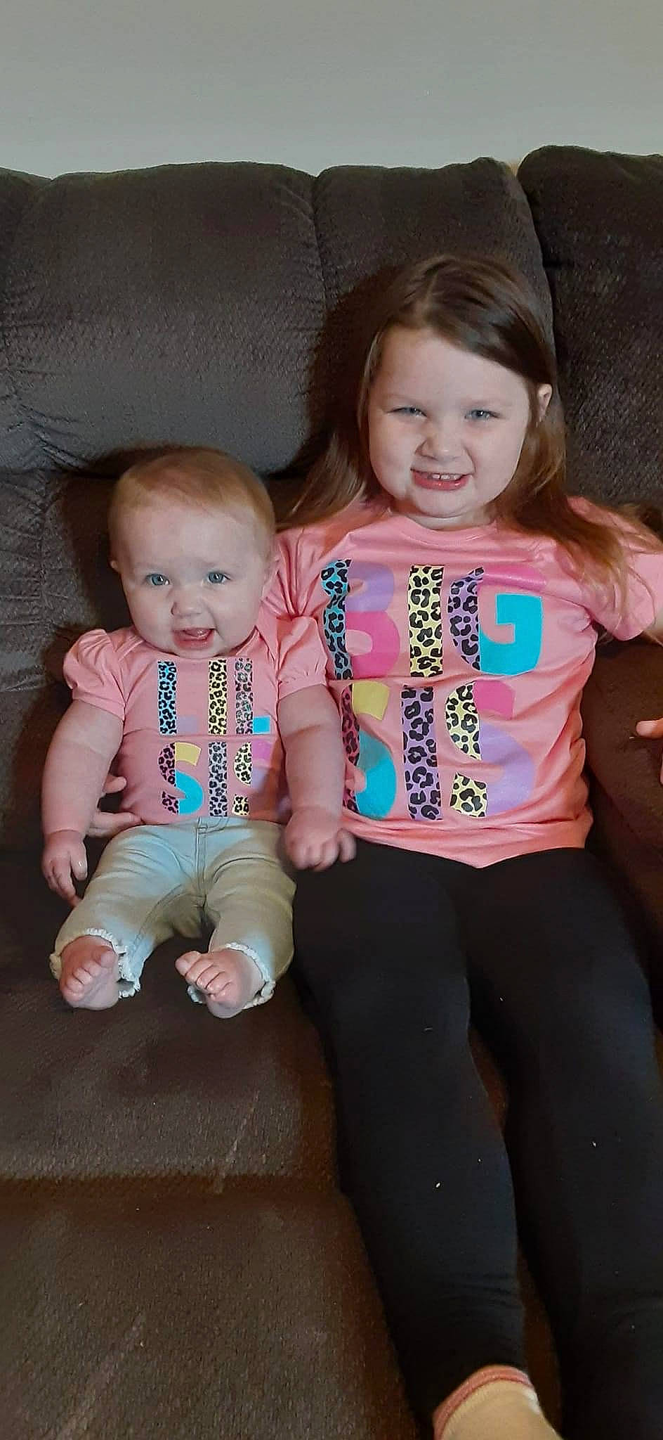 Skylar is registered to the contest to win money with this photo: baby, baby_toddler_clothing, cheek, child, chin, eye, facial_expression, finger, hand, happy, human_body, iris, joy, person, pink, skin, sleeve, smile, standing, t_shirt