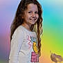 Lola participe au concours pour gagner de l'argent avec cette photo : child, girl, smiling, long_hair, curly_hair, white_shirt, colorful_shirt, smiley_face, stars, pants, standing, portrait, happy, casual_clothing, indoors, pastel_background, gradient_background, youth, person, cute