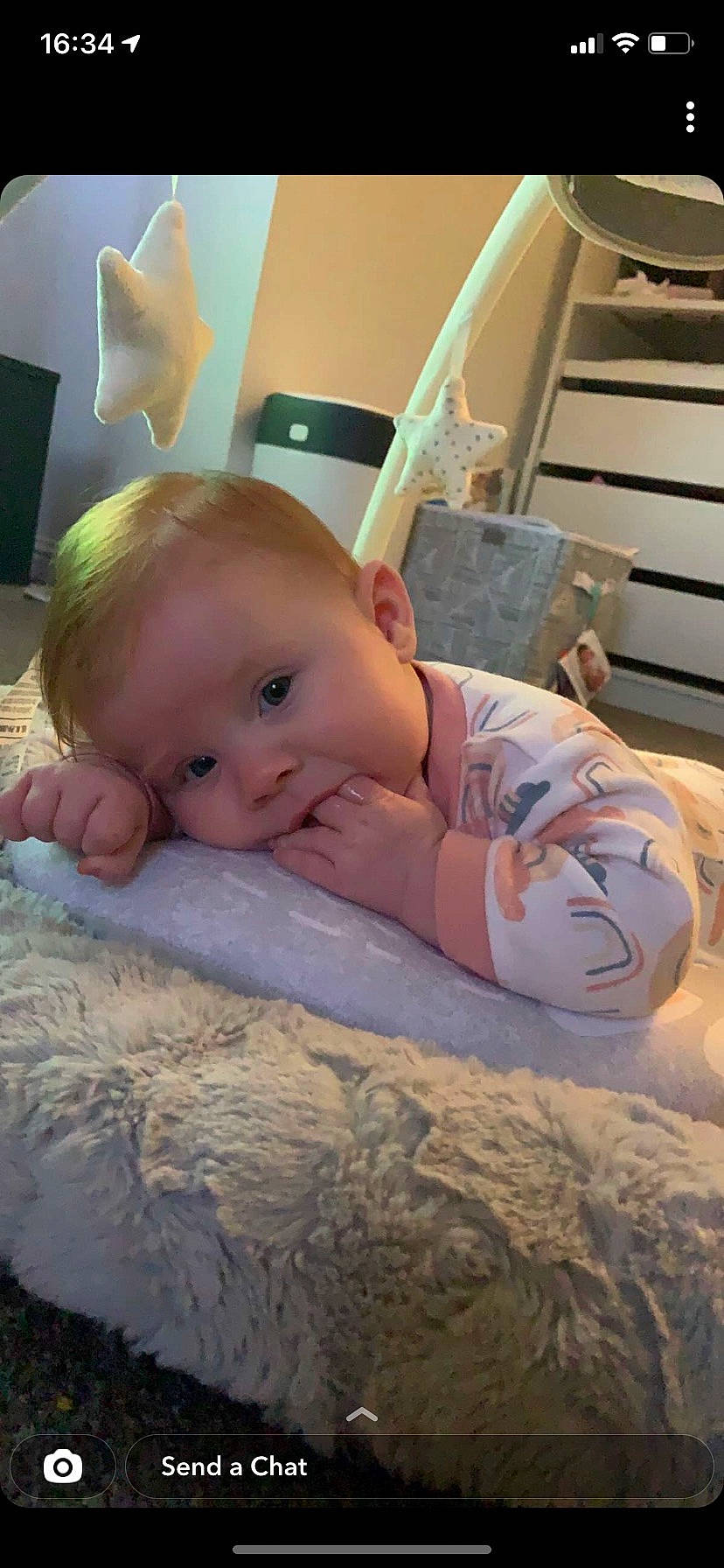 Cassie is registered to the contest to win money with this photo: baby, baby_toddler_clothing, cheek, child, chin, comfort, eye, eyebrow, facial_expression, finger, flooring, happy, iris, mouth, nose, person, skin, smile, thumb, toddler