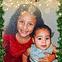 Gracie is registered to the contest to win money with this photo: child, children, smiling, curly_hair, dress, red_dress, blue_dress, holiday, christmas, festive, greenery, ornaments, bells, sparkles, portrait, happy, together, family, cute, indoors