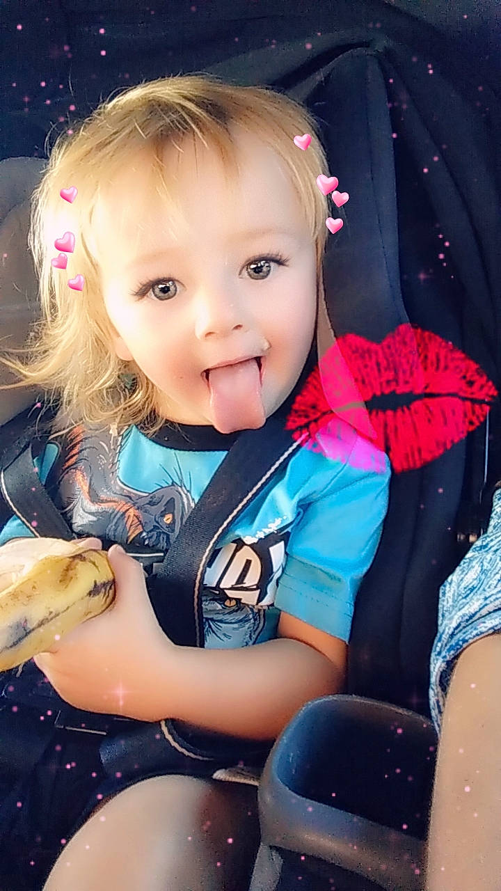 Kingston is registered to the contest to win money with this photo: baby, baby_toddler_clothing, brown_hair, cheek, child, electric_blue, eye, eyelash, facial_expression, finger, fun, grass, happy, human, iris, person, sitting, skin, sleeve, t_shirt