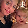 Lucas joined the competition — help win amazing prizes! woman, baby, child, smile, face, indoor, portrait, holding, happy, person, curly_hair, blonde_hair, skin, hand, nail_polish, cabinet, curtain, closeup, family, cozy