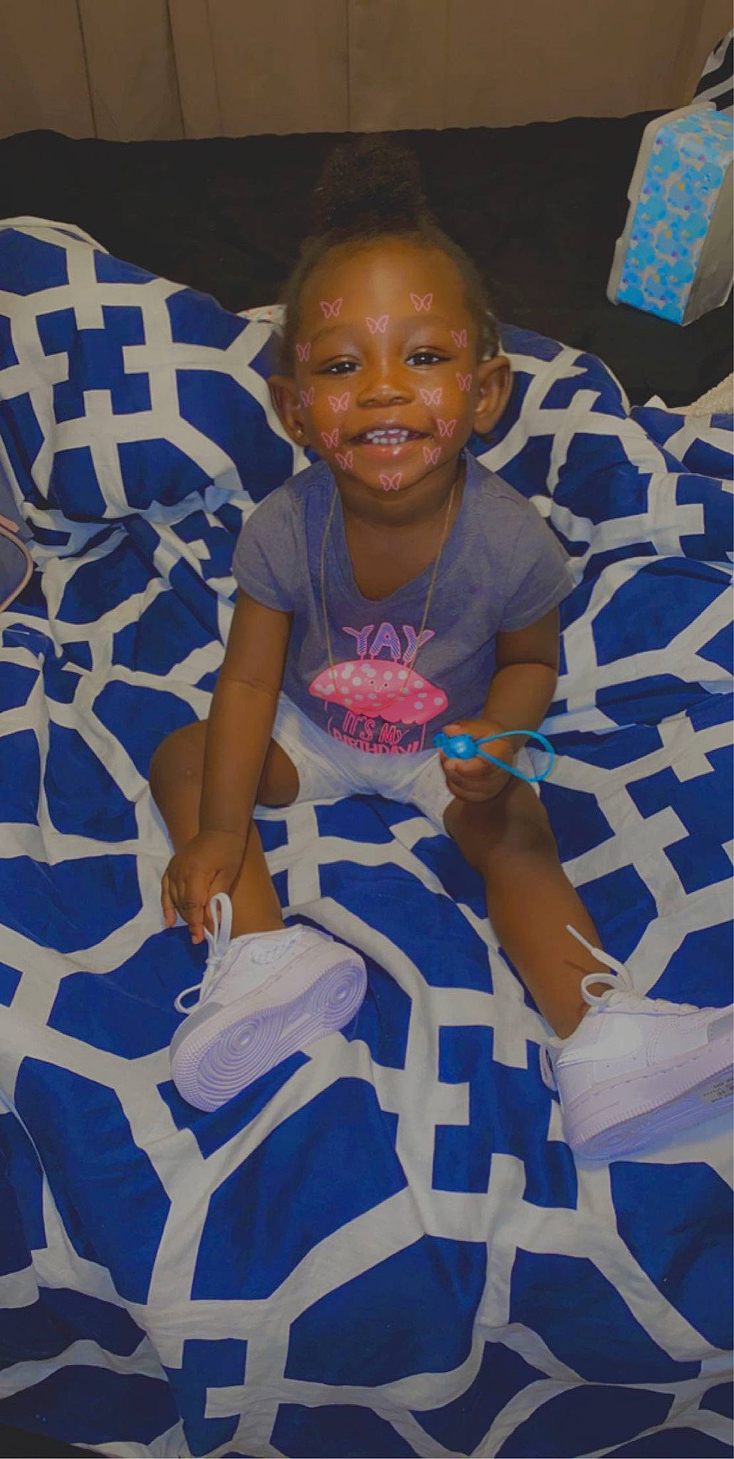 Dionnie is registered to the contest to win money with this photo: baby, blue, child, joy, linens, person, sitting, smile, textile, toddler