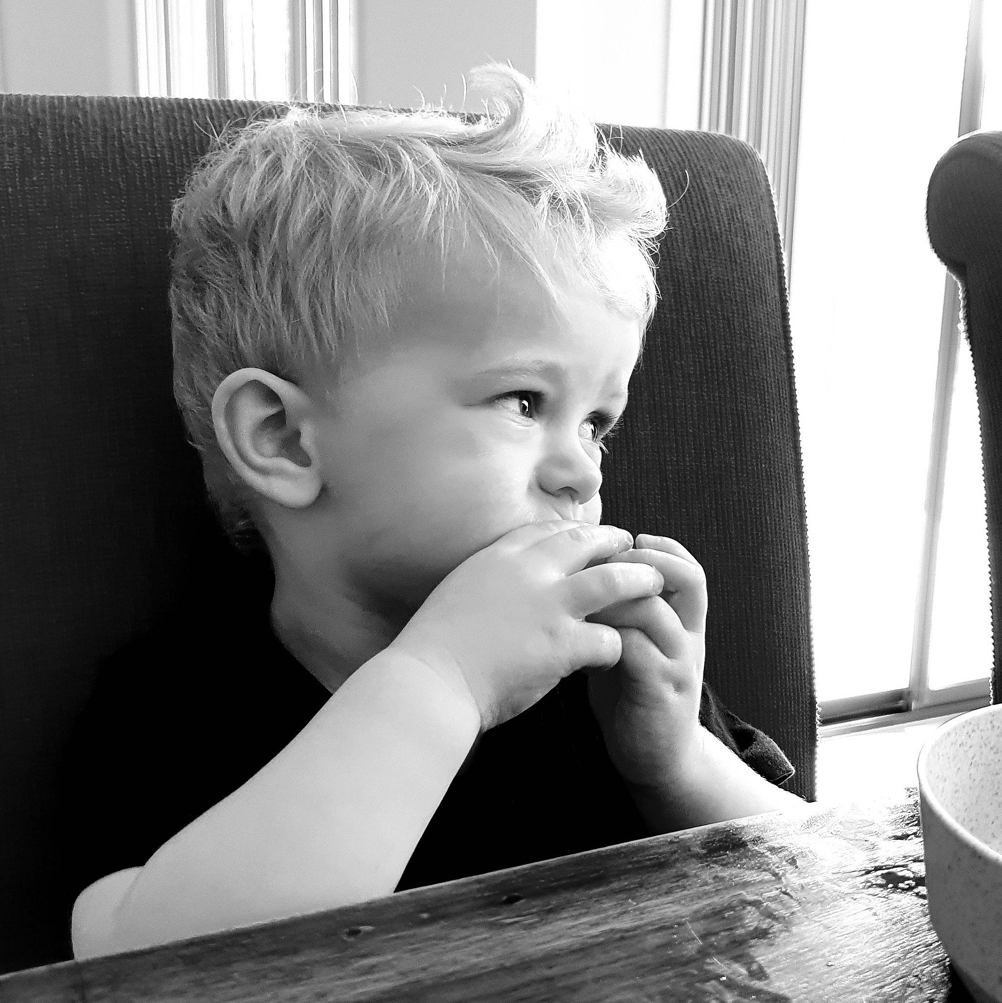 Brooklyn is registered to the contest to win money with this photo: black, black_and_white, cheek, child, eye, eyebrow, eyelash, finger, fun, gesture, hairstyle, happy, monochrome, monochrome_photography, nose, person, snapshot, style, table, toddler