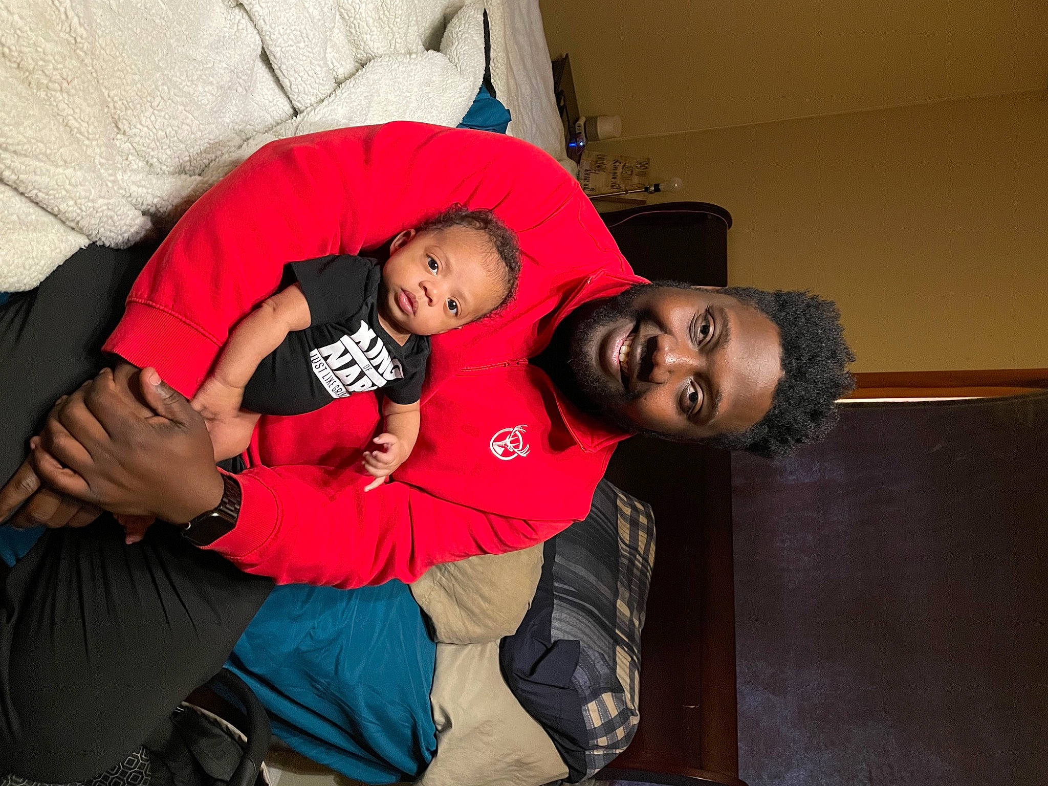 Jayden is registered to the contest to win money with this photo: comfort, couch, elbow, event, facial_expression, flash_photography, fun, happy, human_body, interaction, joint, joy, knee, lap, leg, mouth, person, shoulder, smile, t_shirt