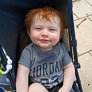 Jamesyn joined the competition — help win amazing prizes! toddler, child, smile, red_hair, blue_eyes, stroller, tshirt, sitting, outdoor, pavement, happy, person, baby, casual_clothing, hand, face, portrait, young_child, cute, sunlight