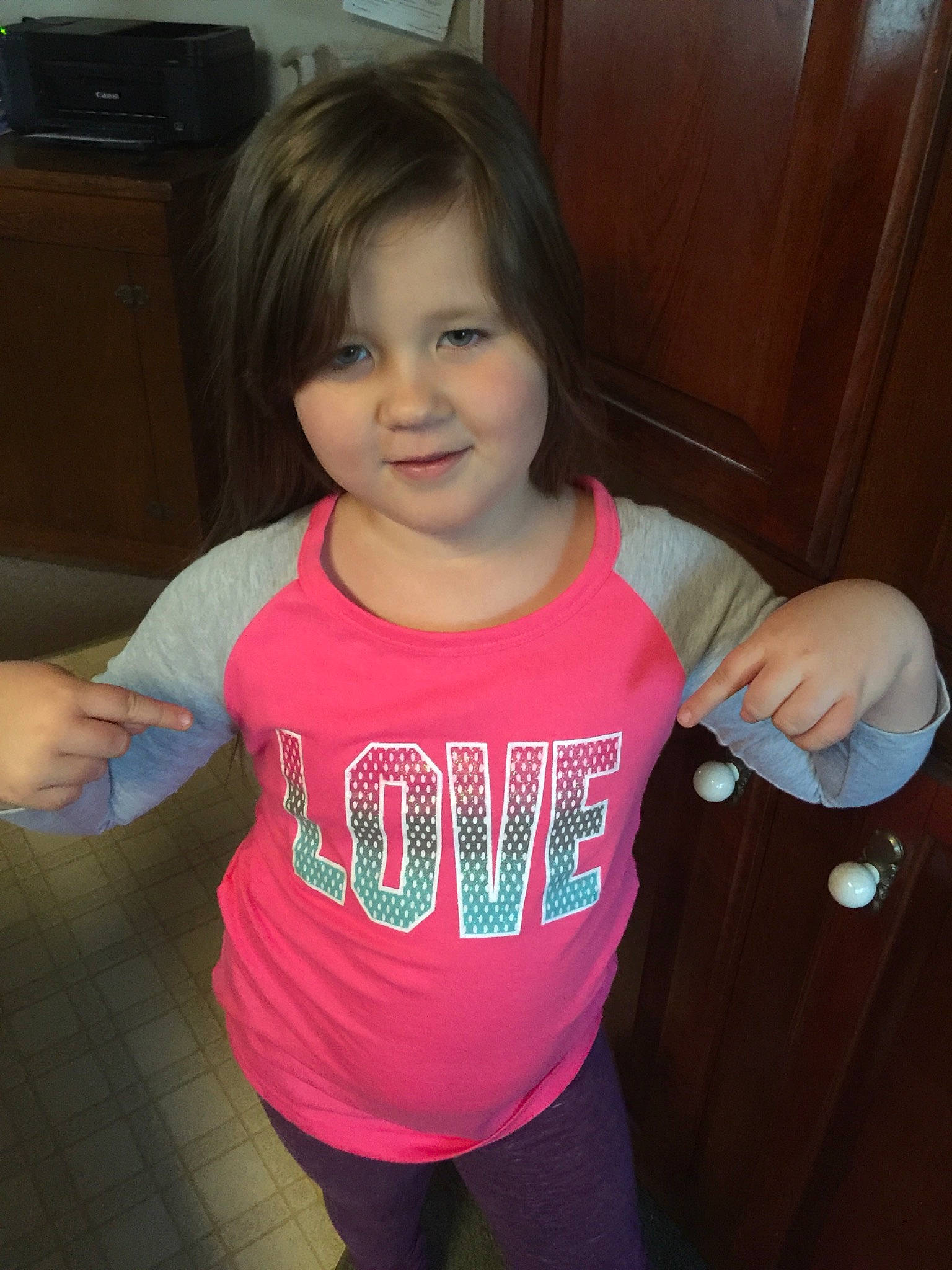 Whitney is registered to the contest to win money with this photo: child, fun, neck, person, pink, shoulder, skin, sleeve, smile, t_shirt, toddler, tooth, top