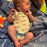 Colter joined the competition — help win amazing prizes! baby, infant, child, bouncer, blanket, portrait, sitting, lying_down, face, hands, feet, onesie, clothing, smiling, indoors, nursery, toy, colorful, cozy, home
