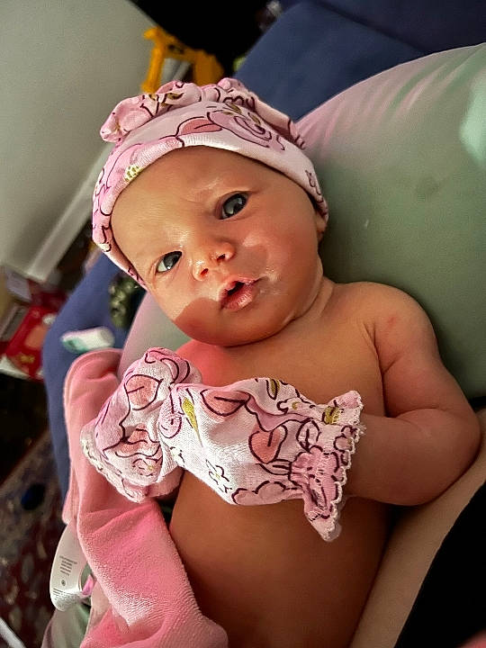 Daisy joined the competition — help win amazing prizes! baby, baby_toddler_clothing, cap, cheek, chest, child, eyelash, fashion_accessory, finger, fun, happy, hat, headwear, human_body, lip, mouth, person, pink, sitting, skin