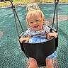 toddler, child, swing, playground, smiling, blue_bow, dress, outdoor, park, happy, person, metal_chain, play, fun, daylight, grass, trees, car, safety_surface, cute