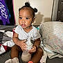 Jazlynn joined the competition — help win amazing prizes! toddler, child, baby_bottle, socks, bed, pillow, hair_puffs, gray_shirt, indoor, person, cute, infant, young_child, holding, sitting, blanket, multicolored, expression, home, cozy
