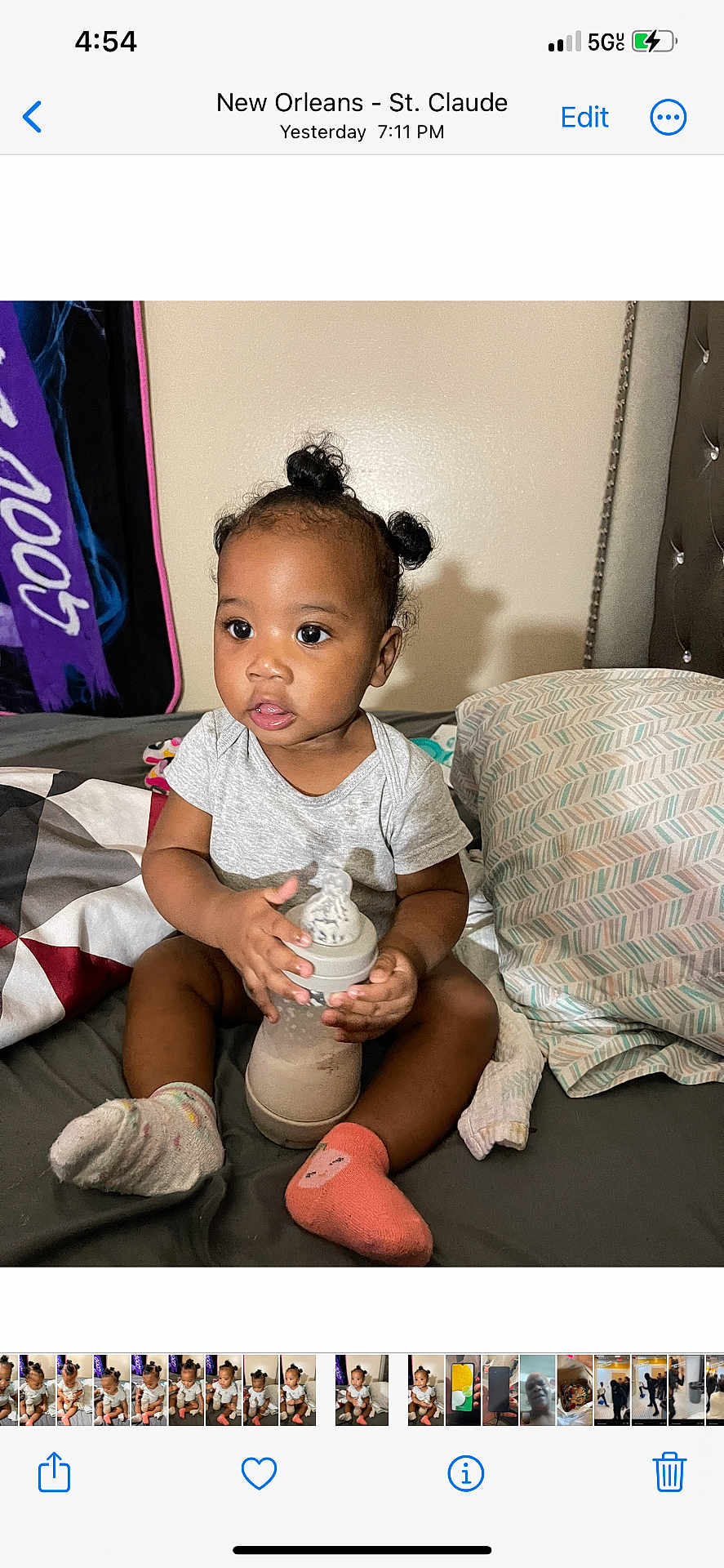 Jazlynn joined the competition — help win amazing prizes! toddler, child, baby_bottle, socks, bed, pillow, hair_puffs, gray_shirt, indoor, person, cute, infant, young_child, holding, sitting, blanket, multicolored, expression, home, cozy