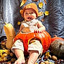 élio participe au concours pour gagner de l'argent avec cette photo : baby, pumpkin, autumn_leaves, nuts, orange_beanie, beige_outfit, fall, smiling, sitting, cozy, festive, harvest, background_fabric, cute, child, seasonal, nature, still_life, holiday, portrait