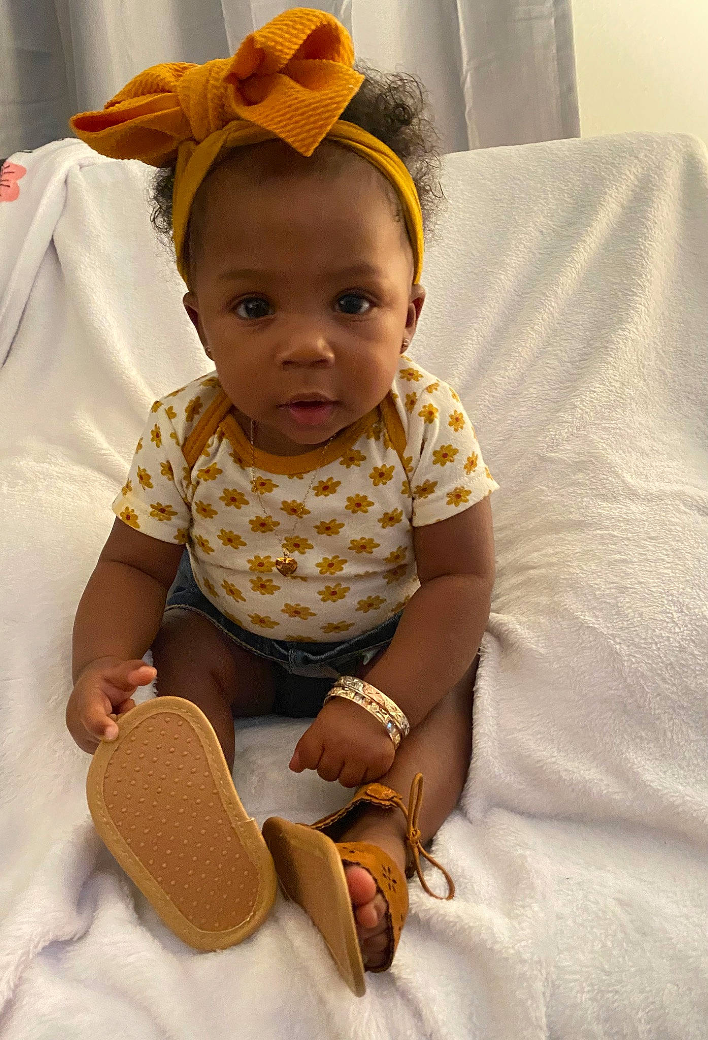 Cevyn is registered to the contest to win money with this photo: arm, baby, baby_toddler_clothing, child, chin, comfort, eye, facial_expression, finger, flooring, fun, happy, head, human_body, person, sitting, skin, sleeve, standing, textile