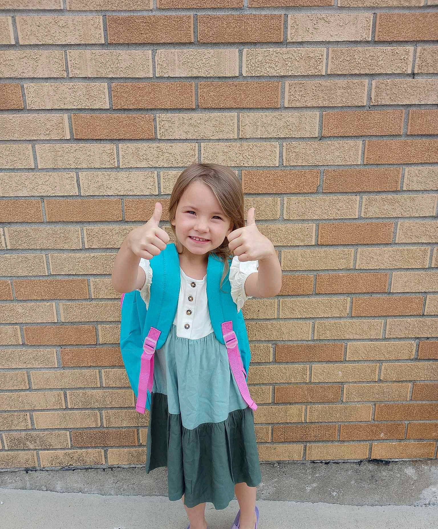 Elizabeth joined the competition — help win amazing prizes! brick, brickwork, child, electric_blue, fun, gesture, grass, hair, hand, happy, joy, leisure, magenta, outerwear, pattern, person, pink, sitting, sleeve, smile