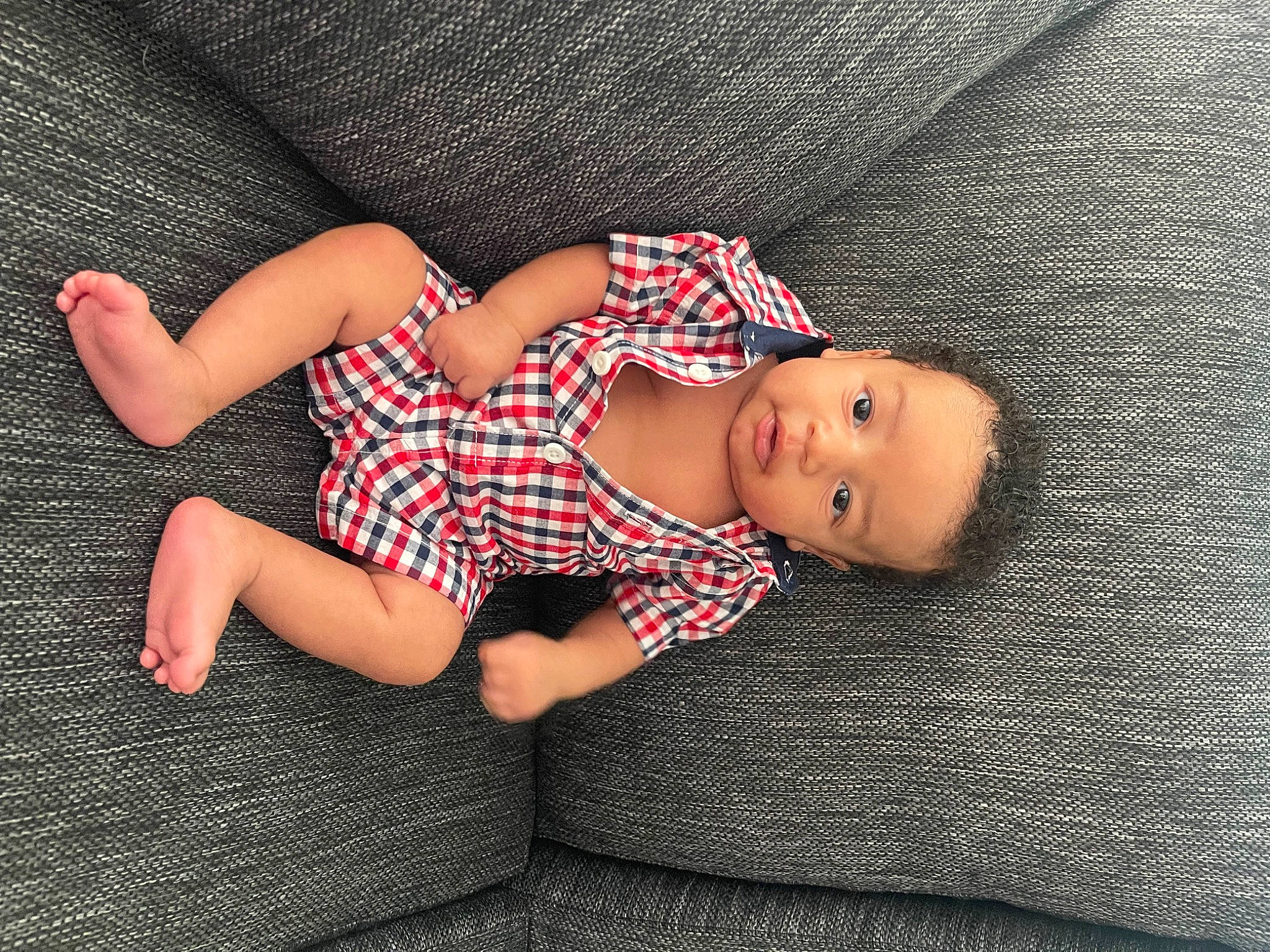 Jasean Stevenson is registered to the contest to win money with this photo: baby, baby_toddler_clothing, carmine, child, comfort, finger, flash_photography, foot, grass, hand, human_leg, knee, leg, linens, pattern, person, sitting, skin, sleeve, thigh
