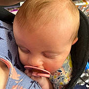 Emery is registered to the contest to win money with this photo: baby, pacifier, sleeping, infant, closeup, face, child, carrier, fabric, pattern, floral, comfort, peaceful, soft, head, skin, clothing, rest, indoors, person