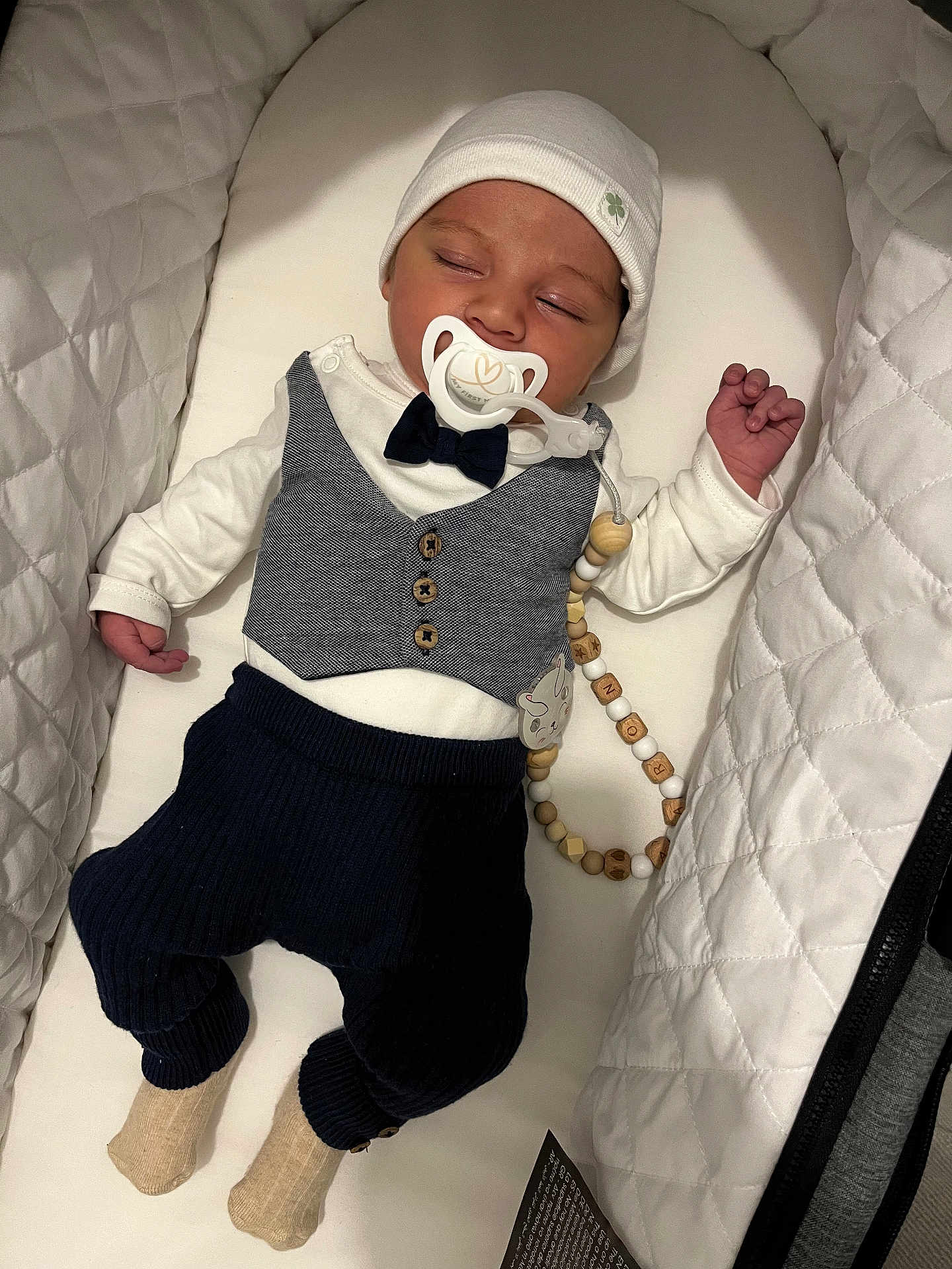 Aaron participe au concours pour gagner de l'argent avec cette photo : accessories, baby, bed, blanket, bonnet, cap, clothing, cradle, crib, face, formalwear, furniture, hat, head, hosiery, infantbed, pants, person, sock, tie