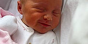 Maisie is registered to the contest to win money with this photo: baby, bed, blanket, child, clothing, cozy, cute, face, indoors, infant, newborn, pacifier, peaceful, pink, portrait, resting, sleeping, smiling, soft, white
