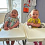 baby, high_chair, smile, indoor, food, snack, pajamas, table, window, fries, face, child, person, happy, cute, kitchen, seat, expression, feeding, infant