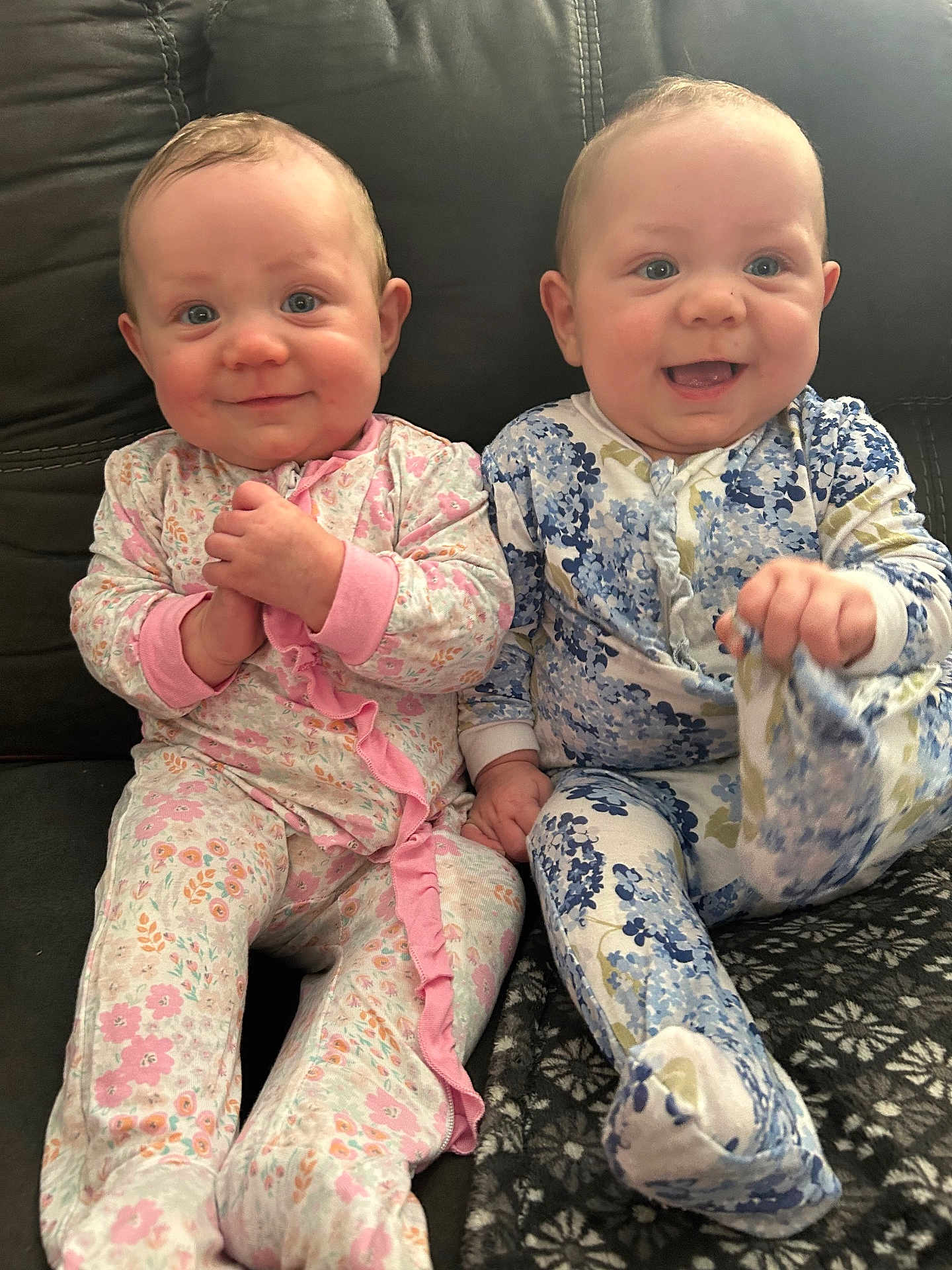 Kaileeanpaisley joined the competition — help win amazing prizes! baby, infant, child, pajamas, floral_pattern, couch, smiling, happy, indoors, cute, sitting, two_children, face, hands, footed_pajamas, light_skin, blue_eyes, pink, blue, cozy