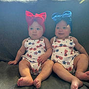 Kaileeanpaisley joined the competition — help win amazing prizes! baby, infant, twin, headband, bow, red_bow, blue_bow, couch, sitting, cute, outdoor_light, patterned_clothing, legs, feet, portrait, child, two_people, indoor, expression, face