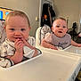 baby, babies, high_chair, indoor, living_room, child, infant, bib, cloth, cute, smile, face, furniture, television, cartoon, window, curtains, air_conditioner, blanket, person