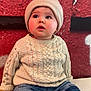 Tao a rejoint le concours — aidez-le/la à gagner de superbes lots ! baby, beanie, brick_wall, casual_clothing, child, colorful_background, curious, cute, face, footwear, headwear, indoor, infant, jeans, knitted_sweater, looking_up, portrait, seated, sneakers, young_child