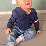 baby, casual_clothing, child, curious, cute, feet, floor, hair, hands, indoor, jacket, jeans, looking_up, person, portrait, sitting, smiling, socks, tiled_floor, young_child