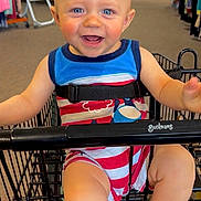 Brantley joined the competition — help win amazing prizes! baby, blue_eyes, cart, child, clothing_store, colorful, cute, happy, indoor, infant, person, retail, seat, seatbelt, shopping, shopping_cart, smile, store, striped_outfit, toddler