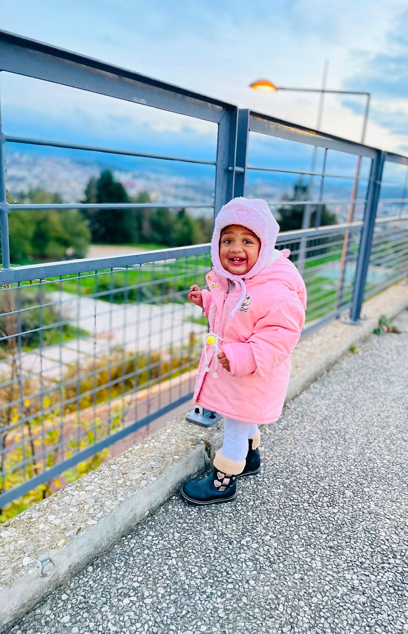 Syannah participe au concours pour gagner de l'argent avec cette photo : baby_toddler_clothing, child, cloud, fence, footwear, fun, grass, happy, hat, headwear, joy, landscape, leisure, magenta, person, plant, recreation, road, sky, smile