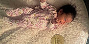 Mia joined the competition — help win amazing prizes! baby, infant, newborn, onesie, floral_pattern, blanket, soft_texture, wooden_plaque, one_month, lying_down, cute, small_hands, small_feet, sleepy, portrait, indoors, child, person, milestone, celebration