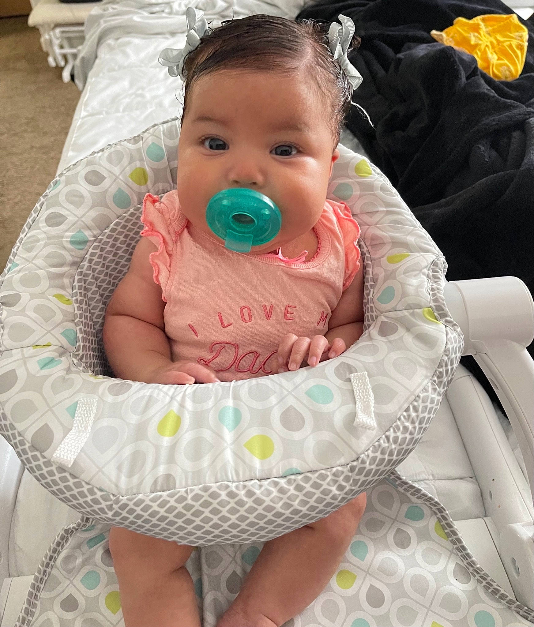Zaylina is registered to the contest to win money with this photo: baby, baby_products, baby_toddler_clothing, bib, chair, cheek, child, comfort, event, eye, happy, head, linens, mouth, pattern, person, pink, sitting, skin, toddler