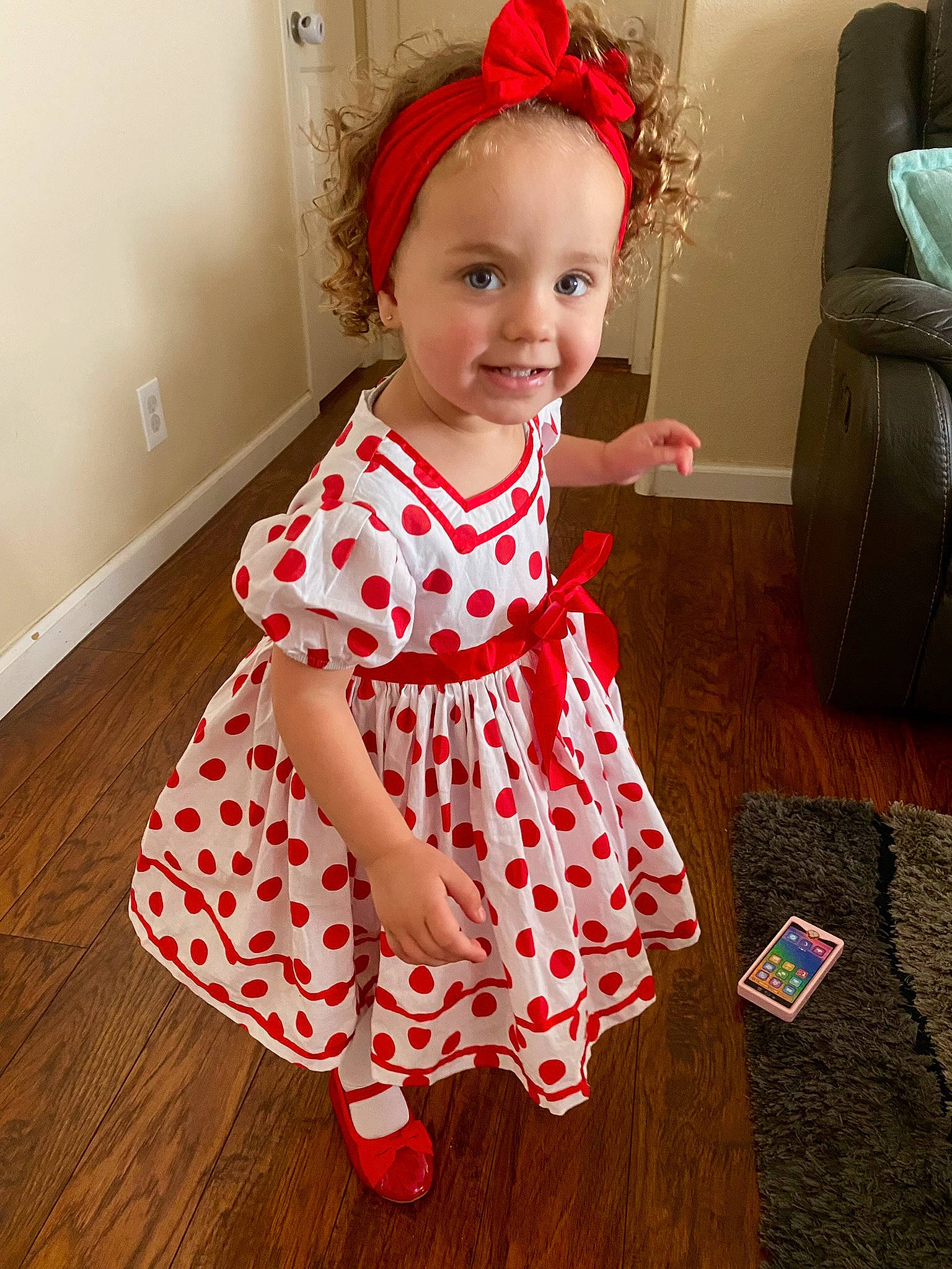 Sofia joined the competition — help win amazing prizes! baby, baby_toddler_clothing, child, costume_hat, day_dress, dress, face, fashion_accessory, flooring, happy, hardwood, human_leg, joy, magenta, one_piece_garment, pattern, person, sleeve, smile, toddler