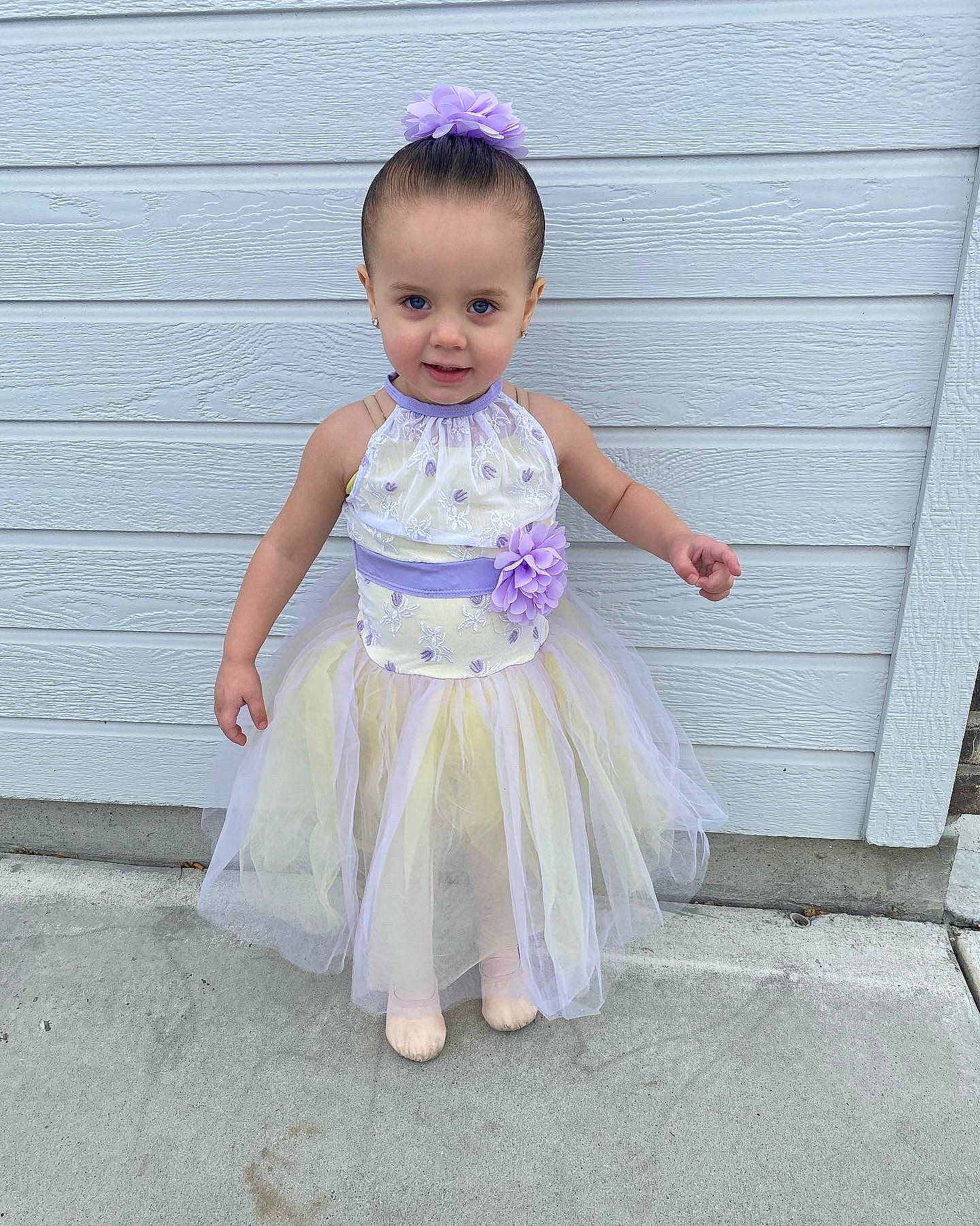 Sofia is registered to the contest to win money with this photo: baby, baby_toddler_clothing, child, child_model, costume, day_dress, embellishment, face, fashion_accessory, happy, human_leg, magenta, pattern, person, pink, ruffle, sitting, sleeve, toddler, waist