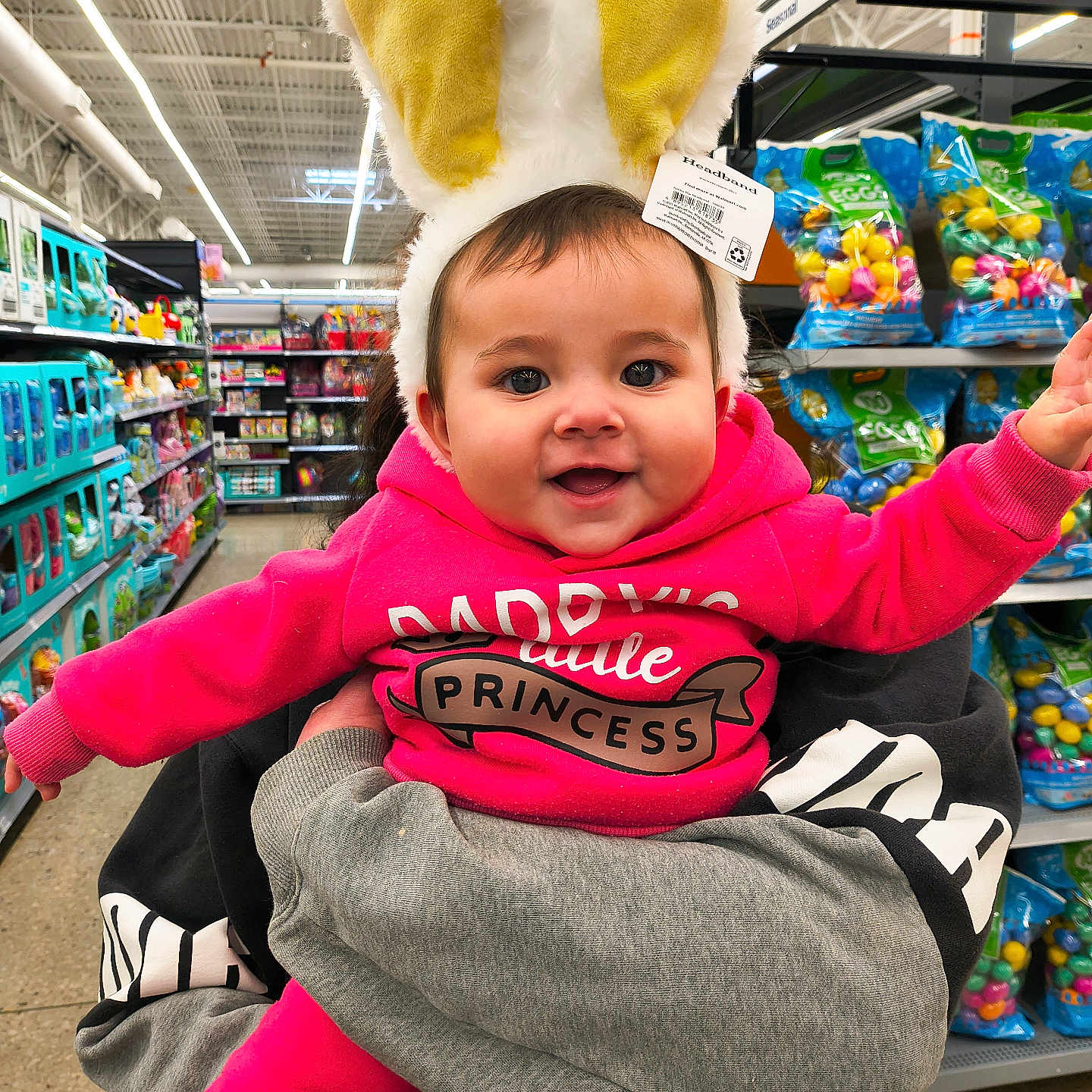 Raven joined the competition — help win amazing prizes! adult_hand, aisle, baby, bunny_ears, child, colorful, happy, headband, holding, infant, person, pink_hoodie, portrait, princess, retail, shelves, shopping, smiling, supermarket, toys