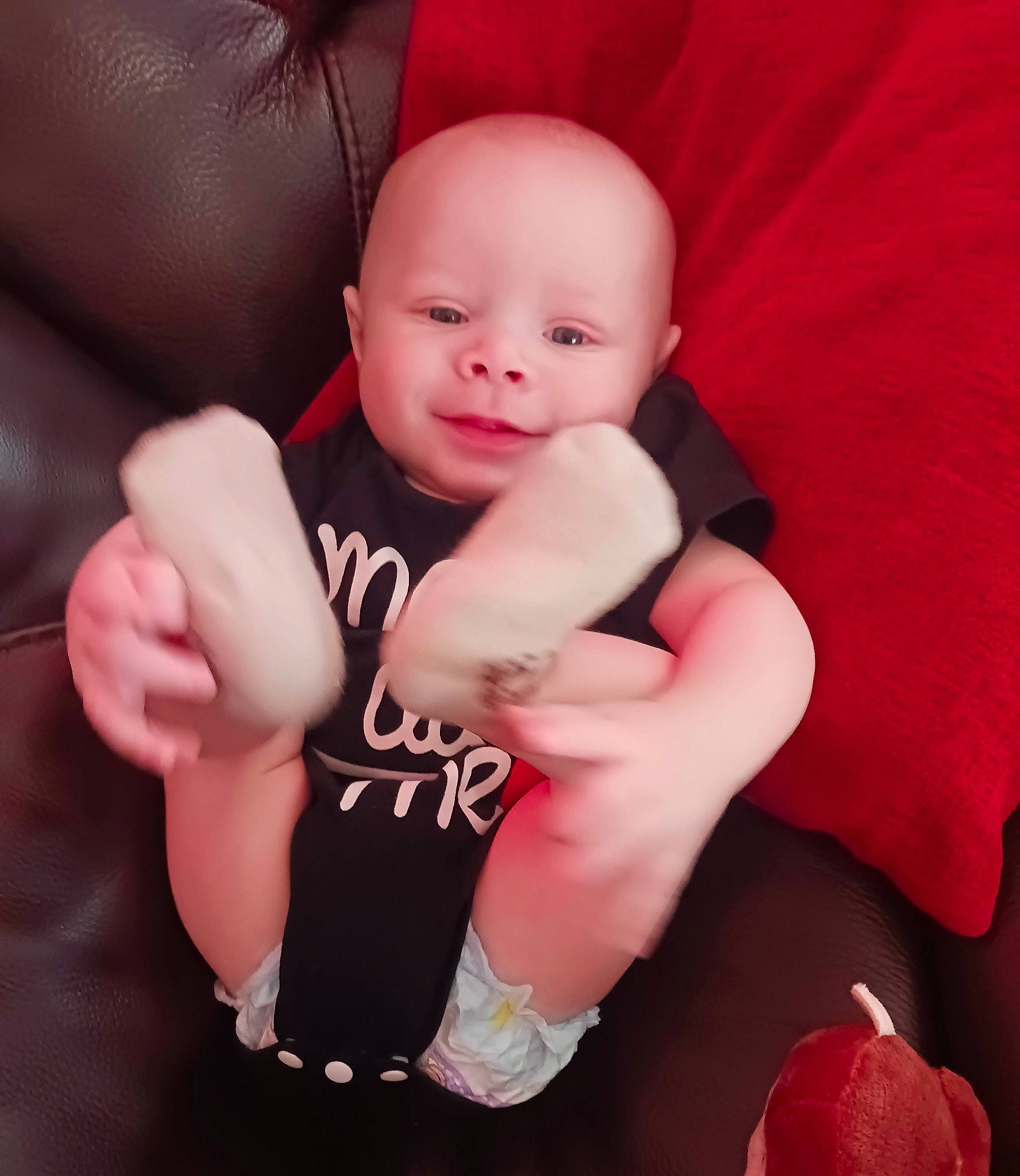 Zavier is registered to the contest to win money with this photo: arm, baby, baby_toddler_clothing, comfort, elbow, eye, finger, gesture, hand, happy, human_body, knee, leg, lip, nail, person, pink, skin, sleeve, thigh