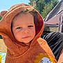 toddler, child, hooded_towel, lion_design, outdoor, sunlight, blue_sky, trees, curly_hair, face, cute, portrait, baby, smile, cozy, warm, person, summer, nature, relaxed