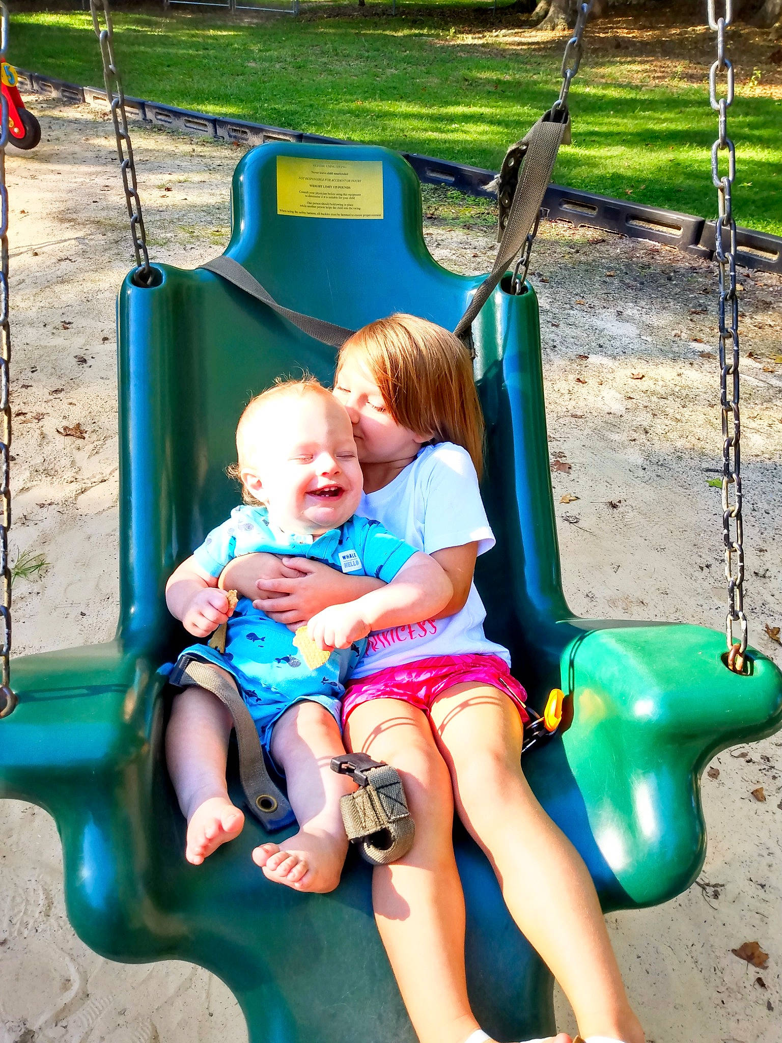 Sawyer joined the competition — help win amazing prizes! aqua, baby_toddler_clothing, blue, facial_expression, fun, grass, green, happy, joy, leisure, person, photograph, pink, playground, product, shorts, skin, smile, summer, swing