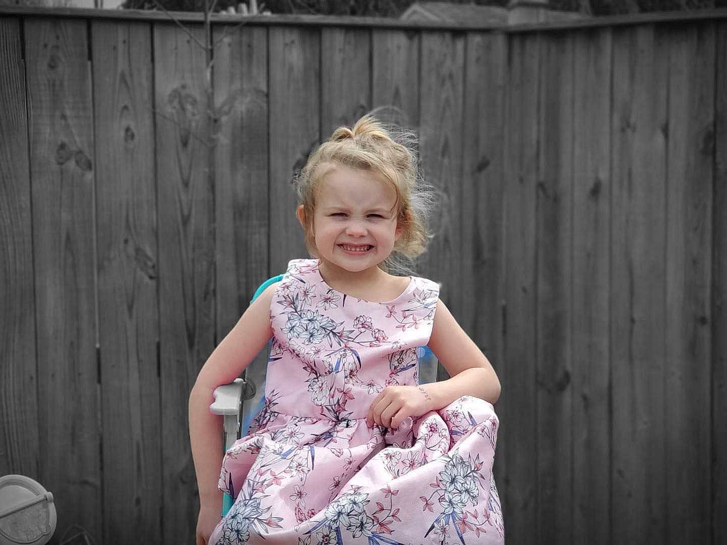 Anna is registered to the contest to win money with this photo: blond, child, child_model, dress, family, fun, joy, pattern, people, person, photograph, photography, pink, plant, sitting, summer, toddler, vacation