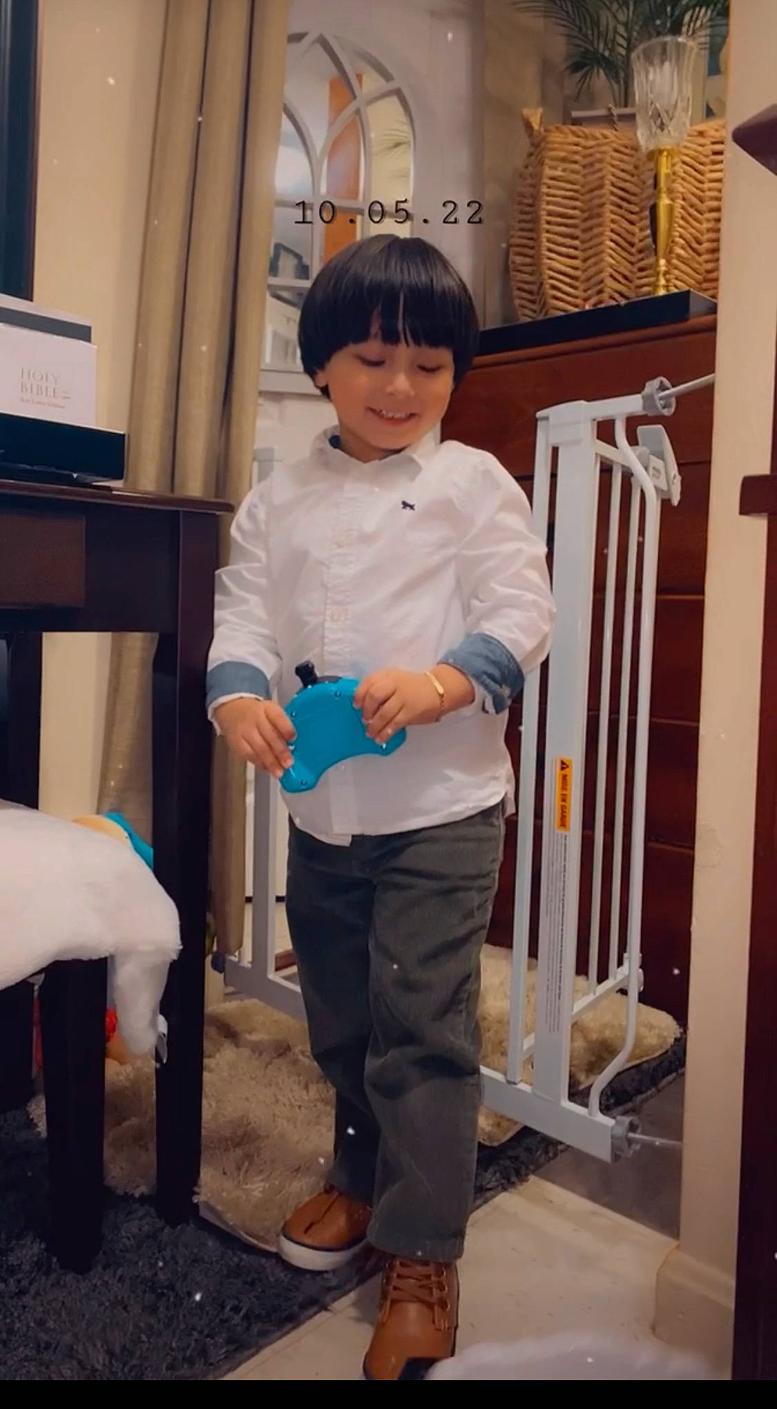 Bradley is registered to the contest to win money with this photo: chair, child, door, electric_blue, event, eye, fun, happy, hat, joy, knee, person, room, sandal, sleeve, smile, t_shirt, toddler, uniform, wood