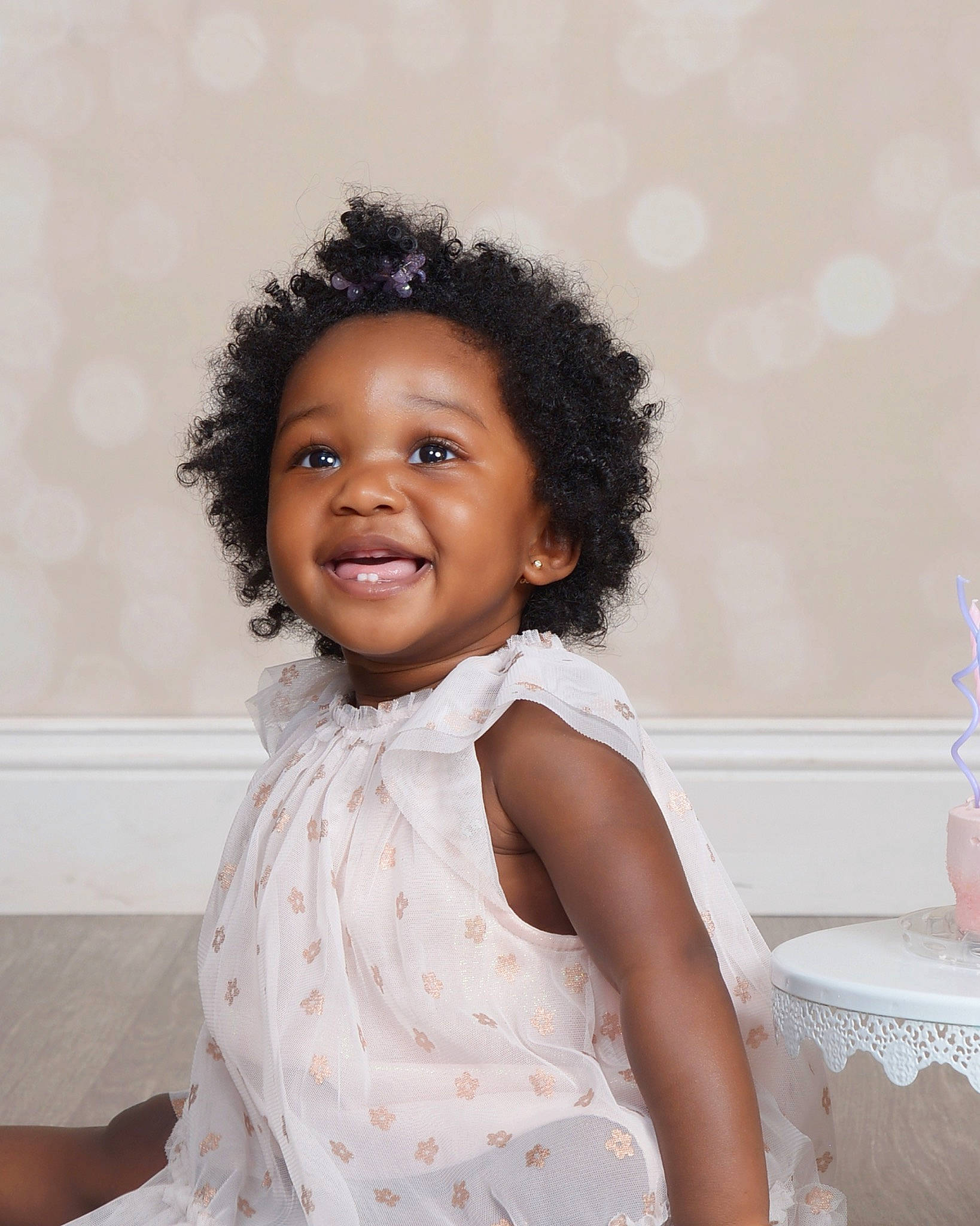 Charleigh is registered to the contest to win money with this photo: afro, baby_toddler_clothing, black_hair, cheek, child, day_dress, fashion_design, flash_photography, gesture, happy, jewellery, joy, pattern, person, portrait_photography, room, sitting, sleeve, smile, table